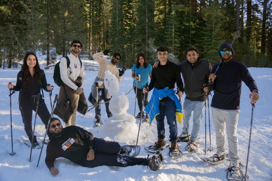 Tiger Escapes attendees standing on snow around a snowman.